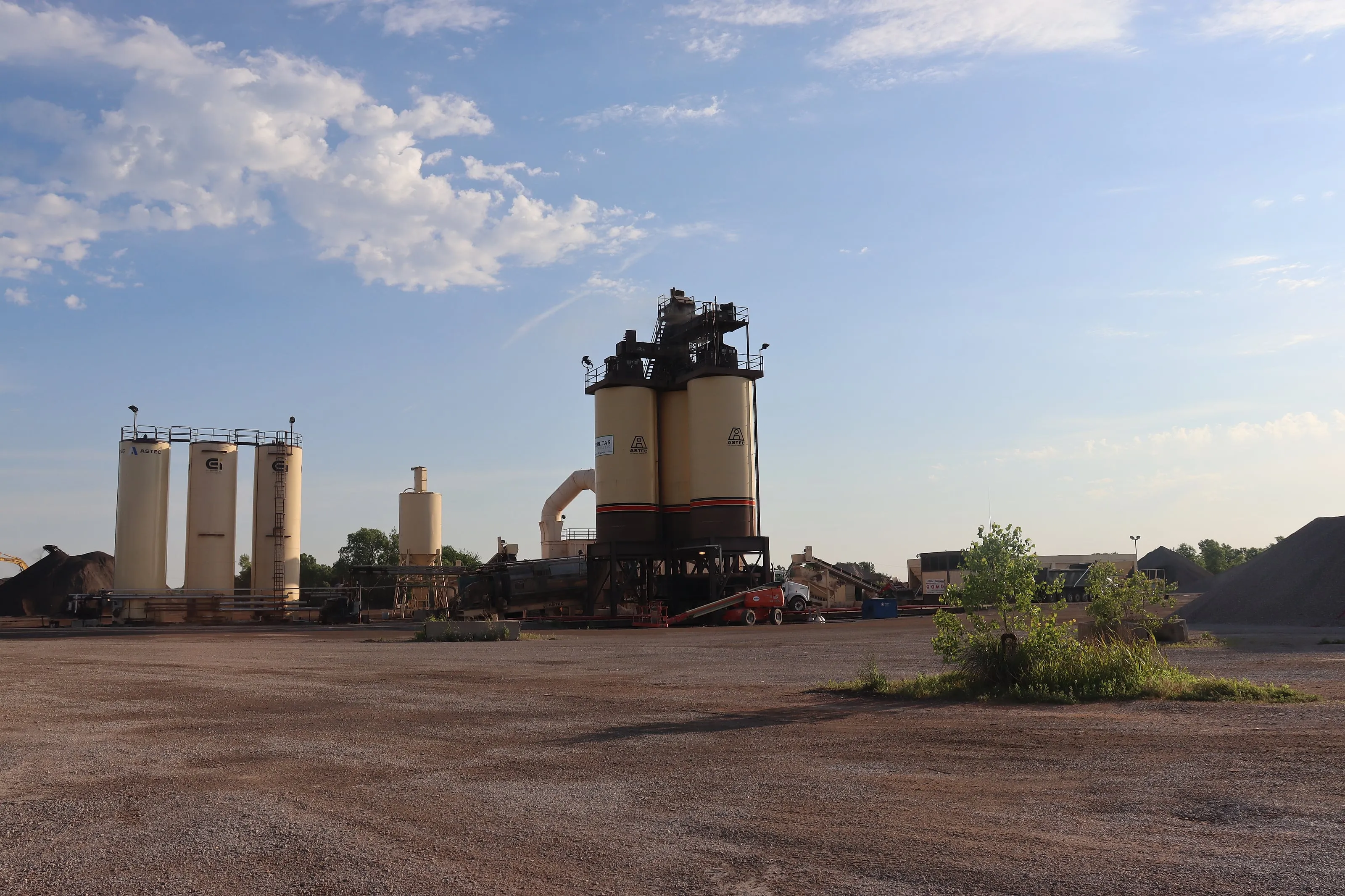 Trinitas plant drum tower and stockpiles under a dramatic sky